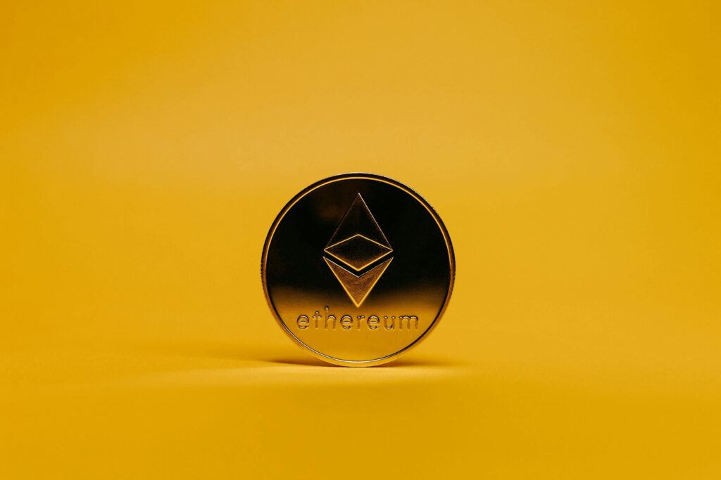 Ethereum coin on yellow background